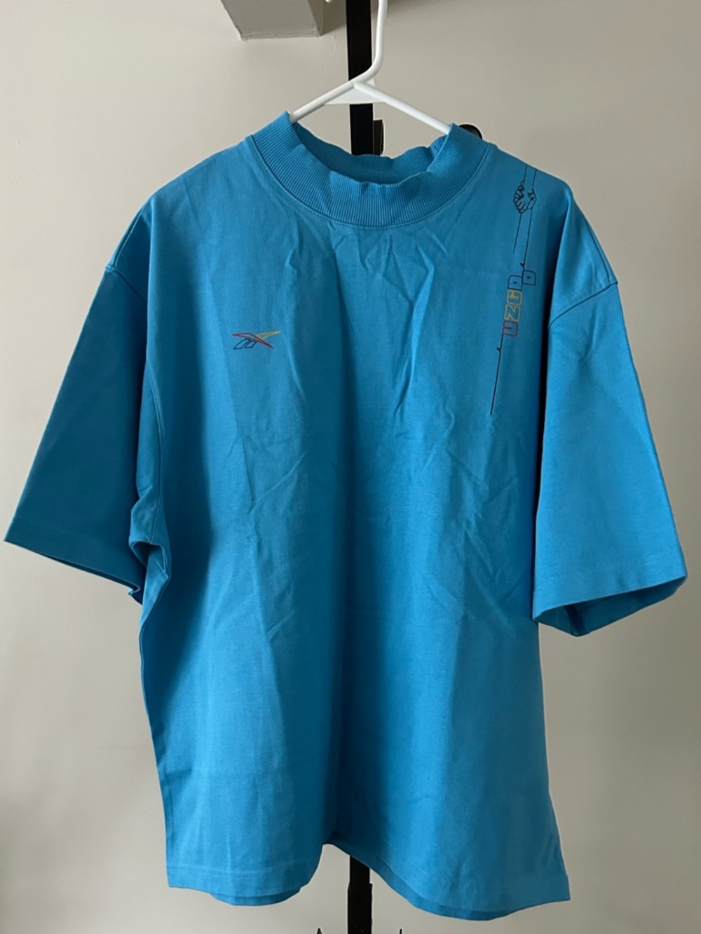 Reebok Men’s Bright Blue Short Sleeve Classic Tee by Pyer Moss, Size X-Large.